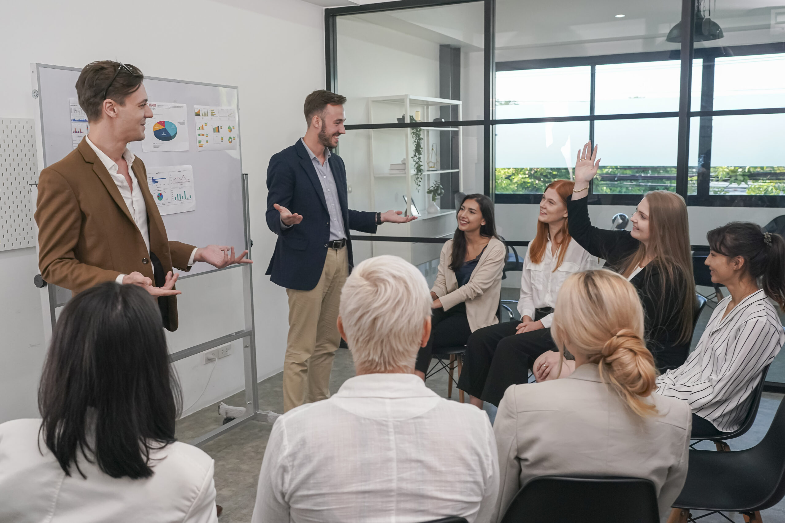 A sales training session where participants listen and respond to a facilitator.